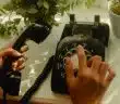 person holding black rotary telephone