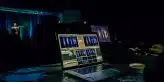 black laptop computer turned on on table